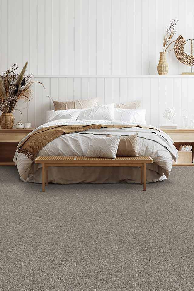 greige carpet in boho chic bedroom with natural wood details